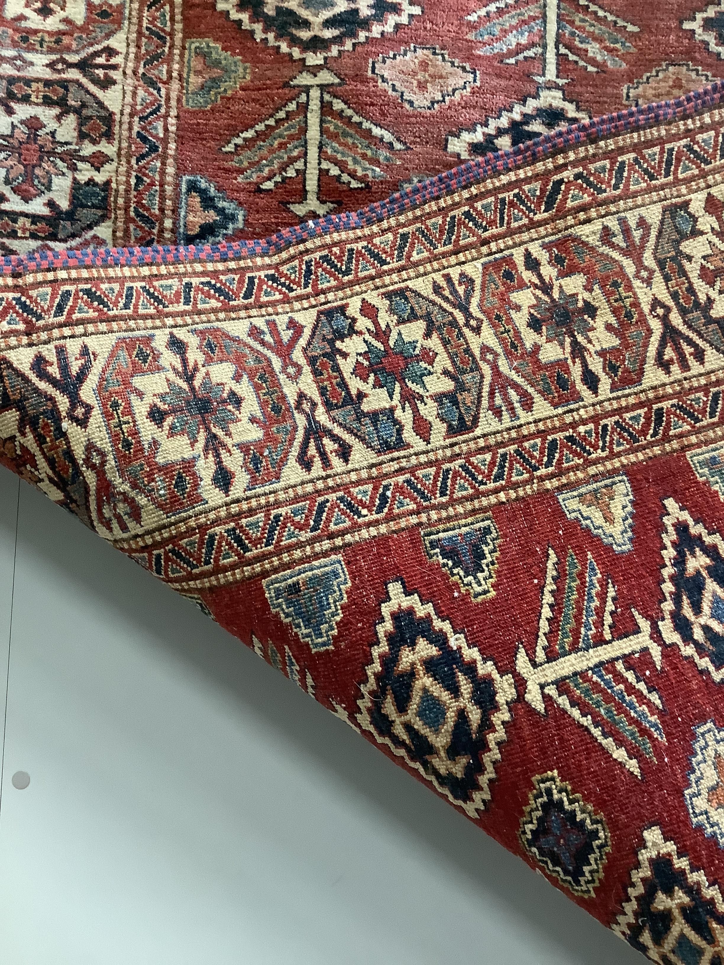 A Caucasian style red ground rug, 170 x 143cm